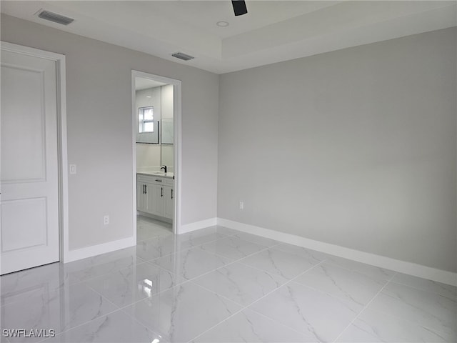 interior space featuring ceiling fan, sink, and connected bathroom