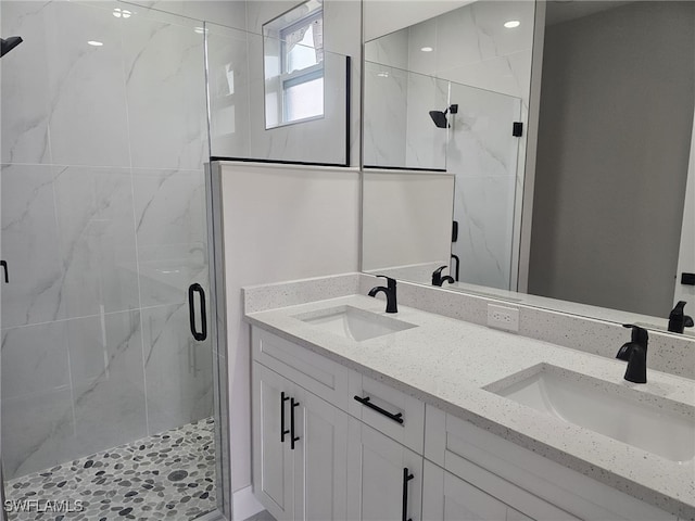 bathroom with walk in shower and vanity