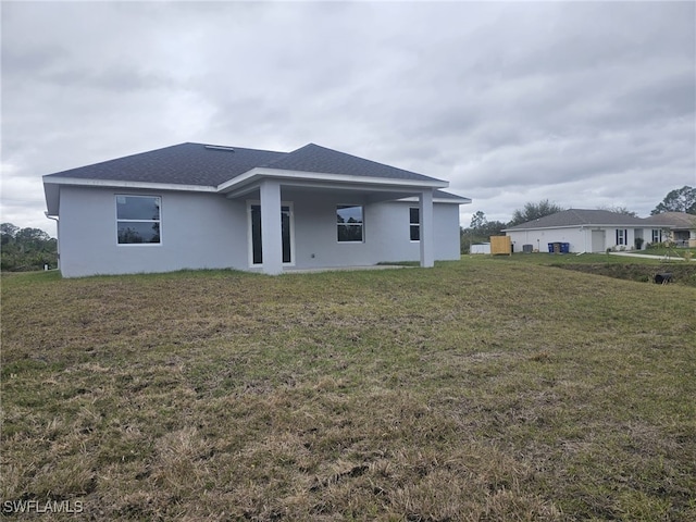 rear view of property with a lawn