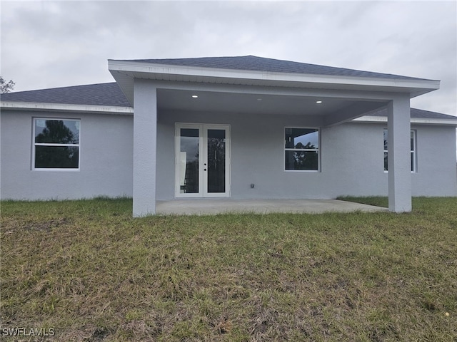 rear view of property featuring a patio area and a yard