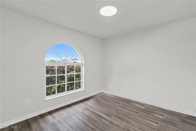 empty room with dark hardwood / wood-style floors