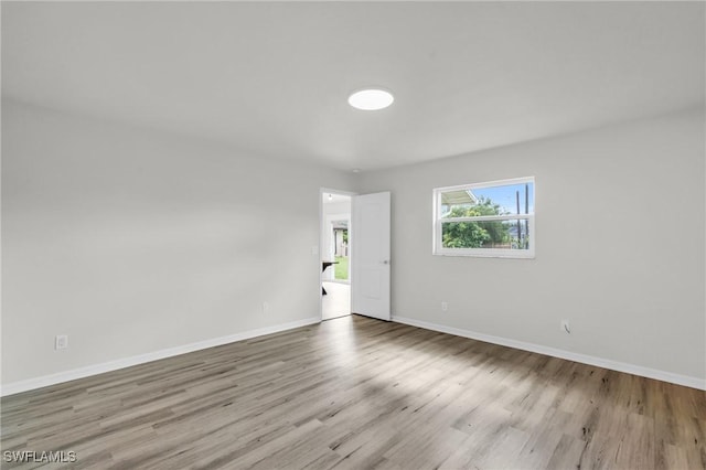 spare room featuring light hardwood / wood-style flooring