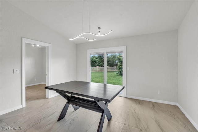 unfurnished dining area with vaulted ceiling