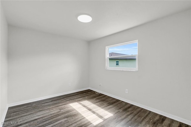 empty room with dark hardwood / wood-style floors