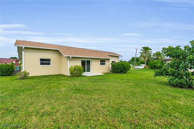 rear view of property with a lawn