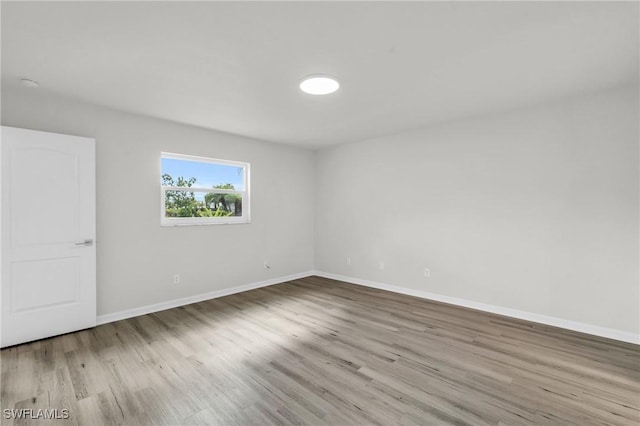 spare room featuring light wood-type flooring