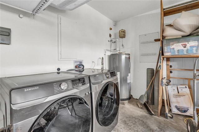 clothes washing area featuring washing machine and clothes dryer and water heater