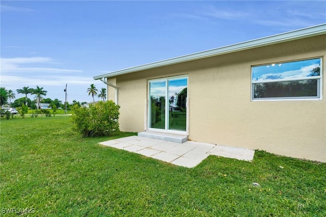 back of property featuring a lawn