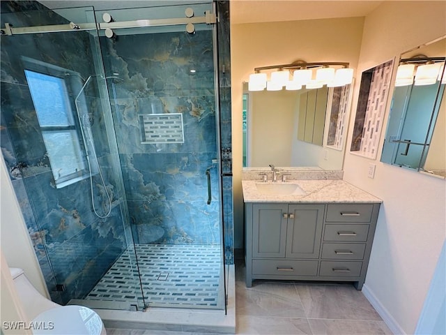 bathroom featuring vanity, plenty of natural light, and a shower with shower door