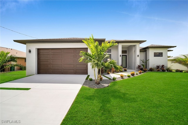 view of front of house with a front yard and a garage