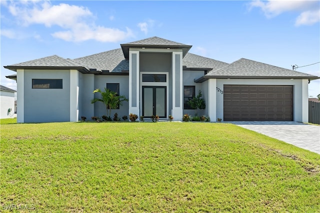 prairie-style house featuring a front lawn and a garage