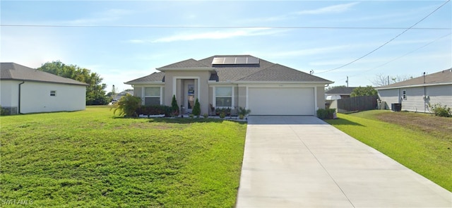 view of front of home featuring a front yard and a garage