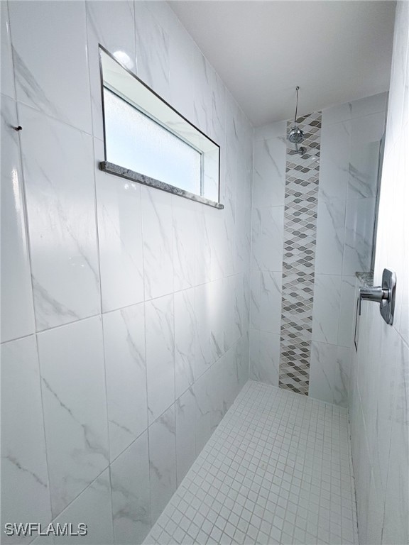 bathroom with a tile shower