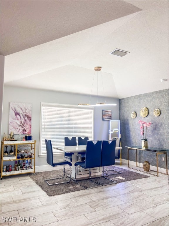 dining space with lofted ceiling