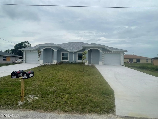 single story home with a garage and a front lawn