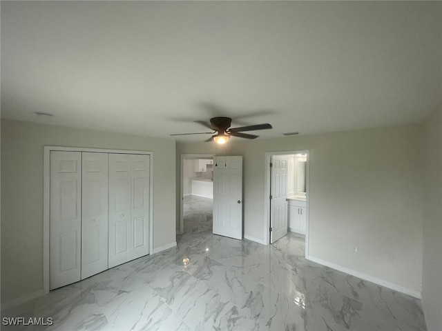 unfurnished bedroom with a closet, ceiling fan, and ensuite bath