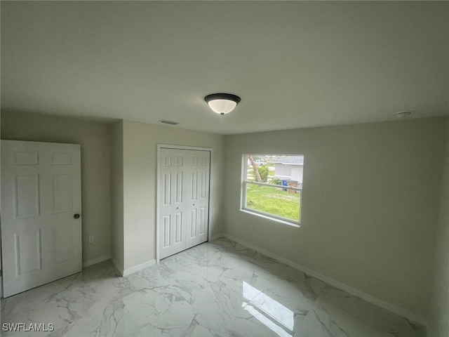 unfurnished bedroom with a closet