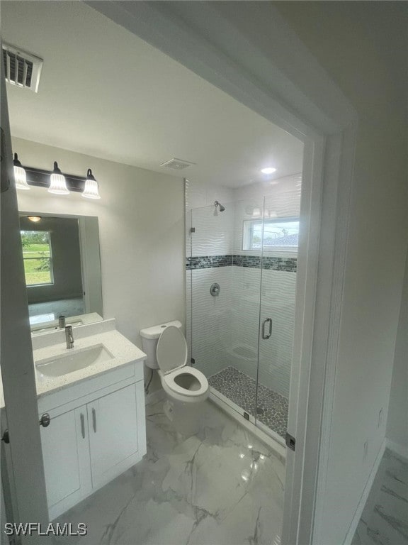 bathroom with walk in shower, vanity, and toilet