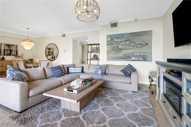 living room with an inviting chandelier, tile patterned flooring, and ornamental molding