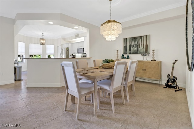 dining area with crown molding, light tile patterned floors, and a notable chandelier