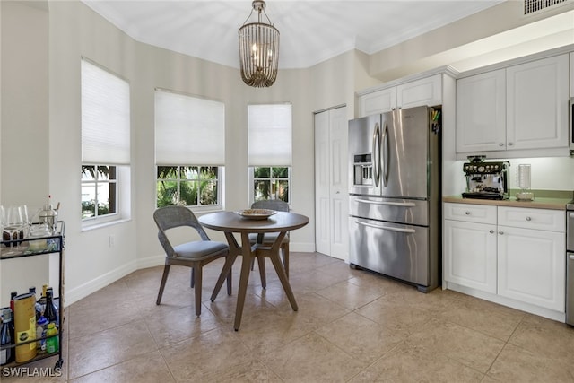 kitchen with pendant lighting, a chandelier, stainless steel fridge with ice dispenser, white cabinets, and ornamental molding