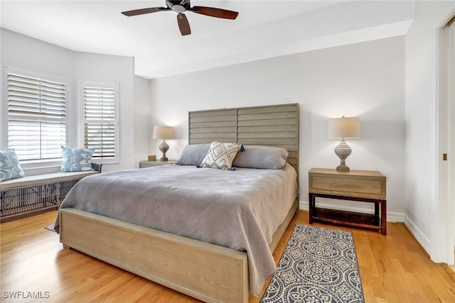 bedroom with ceiling fan and light hardwood / wood-style flooring