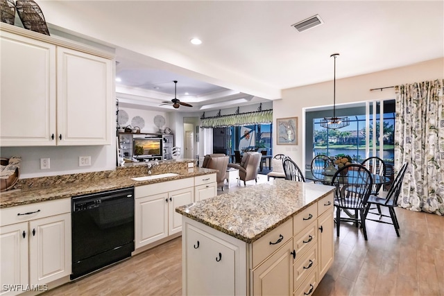 kitchen featuring light wood-type flooring, dishwasher, ceiling fan, and decorative light fixtures