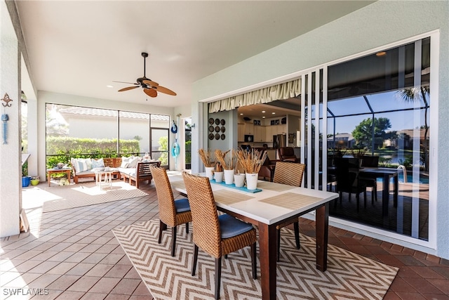 sunroom / solarium featuring ceiling fan