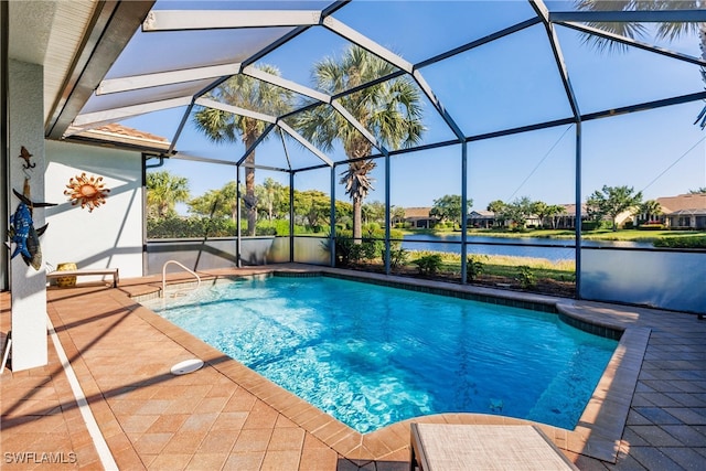 view of swimming pool with a water view, a patio area, and glass enclosure