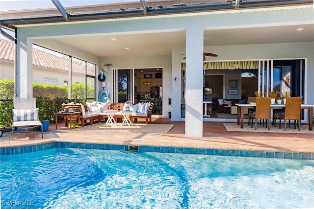 view of swimming pool with a lanai, a patio, ceiling fan, and outdoor lounge area