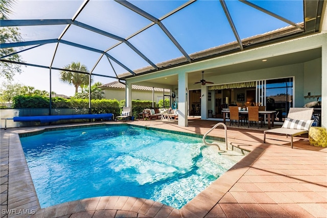 view of swimming pool featuring a lanai, ceiling fan, and a patio area