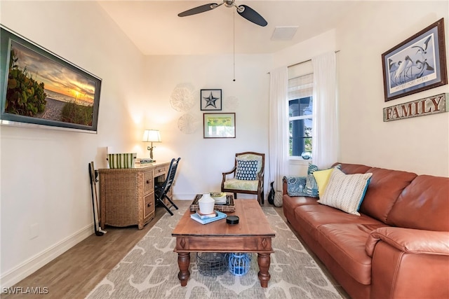 living room featuring ceiling fan and light hardwood / wood-style flooring