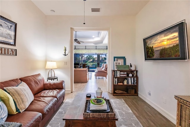 living room with ceiling fan and wood-type flooring