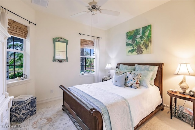 carpeted bedroom with ceiling fan and multiple windows