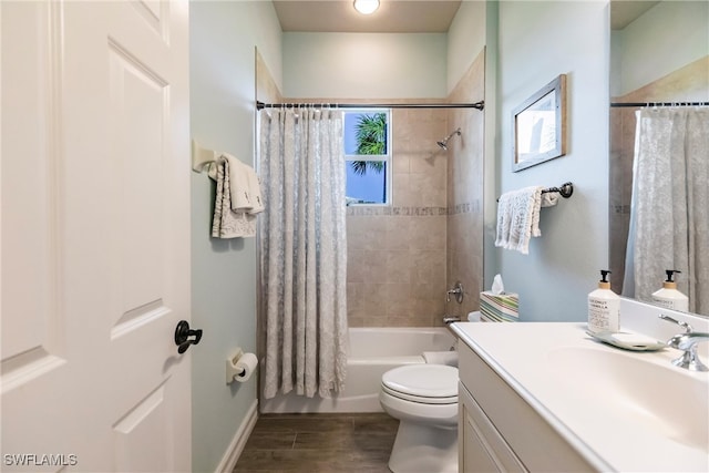 full bathroom with shower / bath combo with shower curtain, hardwood / wood-style flooring, vanity, and toilet