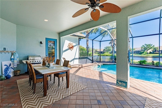 interior space featuring a water view, ceiling fan, and tile patterned floors