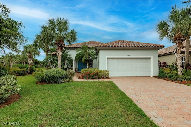 mediterranean / spanish-style house with a garage and a front lawn