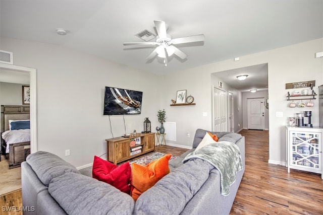 living room featuring ceiling fan and hardwood / wood-style floors