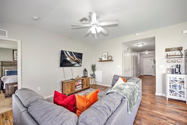 1225 SW 16th Ter, Cape Coral, FL 33991 - living room featuring a ceiling fan, wood finished floors, and baseboards