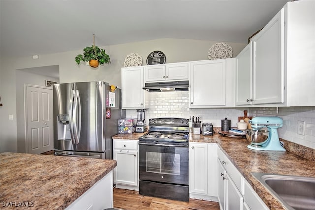 kitchen featuring white cabinetry, electric range, stainless steel fridge, light hardwood / wood-style floors, and vaulted ceiling