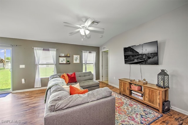 living room featuring light hardwood / wood-style floors, a wealth of natural light, lofted ceiling, and ceiling fan