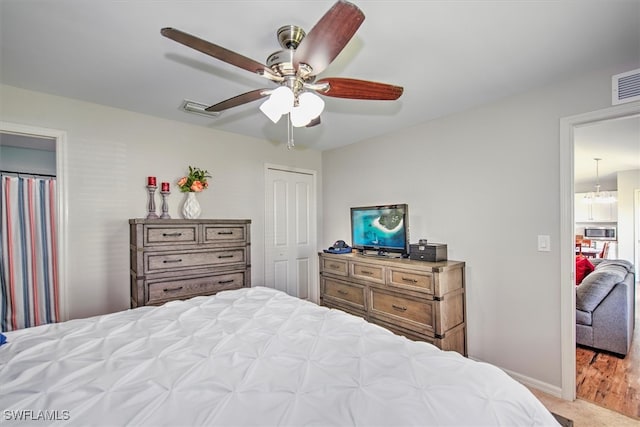 bedroom featuring a closet, light hardwood / wood-style floors, and ceiling fan