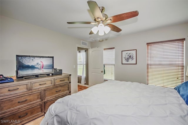 bedroom with multiple windows and ceiling fan