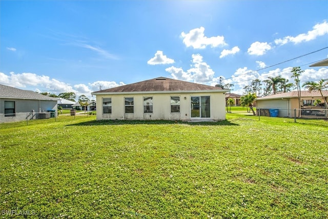 back of property with a lawn