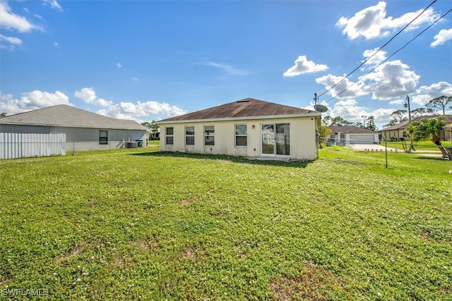 rear view of house featuring a yard