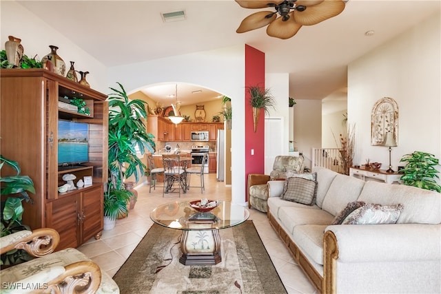 tiled living room featuring lofted ceiling and ceiling fan