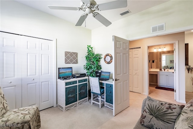 home office featuring light carpet and ceiling fan