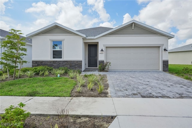 ranch-style house featuring a garage and a front yard