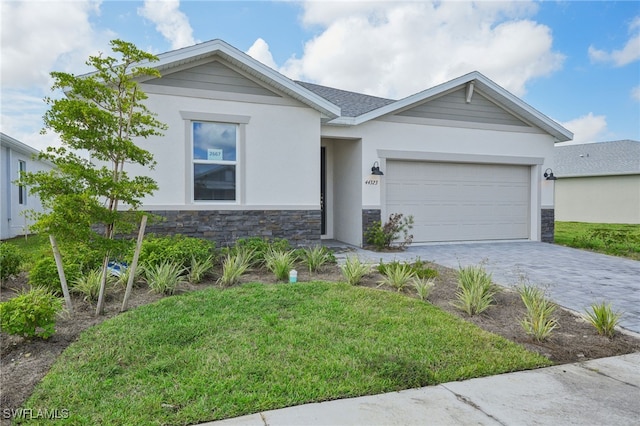 view of front facade with a garage and a front yard