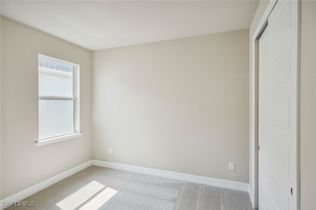 unfurnished bedroom with a closet and carpet flooring